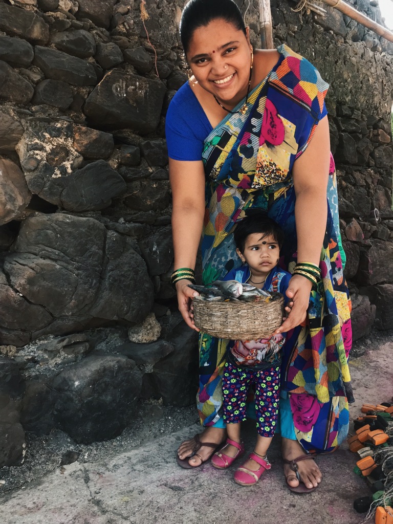Local Woman Smiling & Posing with her  Daughter Holding a Basket Full of Fishes in Mumbai's Worli Village Locality