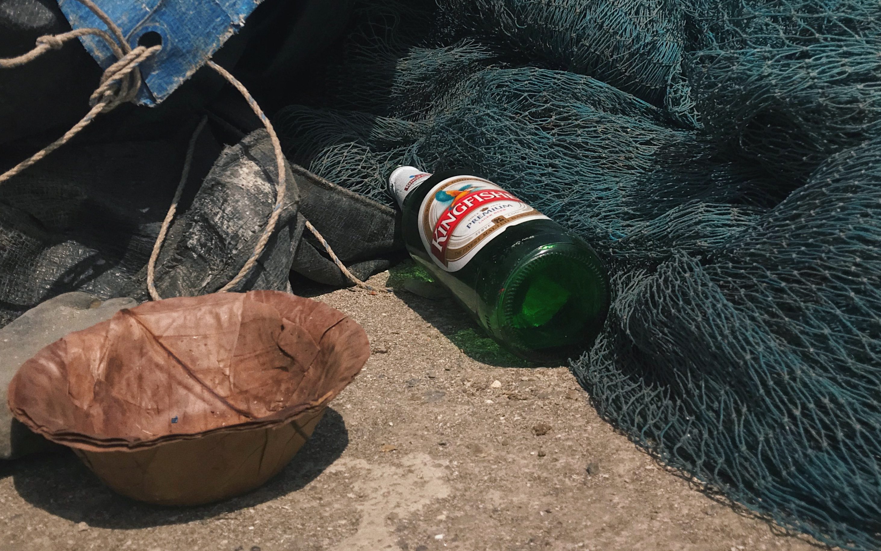 Empty Beer Bottle Next to Fishing Nets in Mumbai's Worli Village Locality