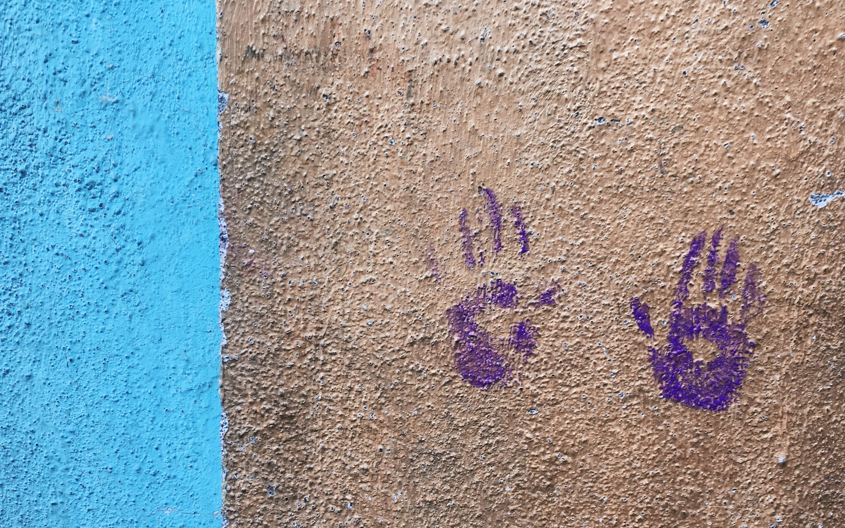 Coloured Hand Prints on a wall in Mumbai's Worli Village Locality